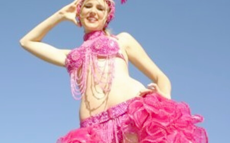 Pink Calypso Showgirl, stilt walker in Brisbane